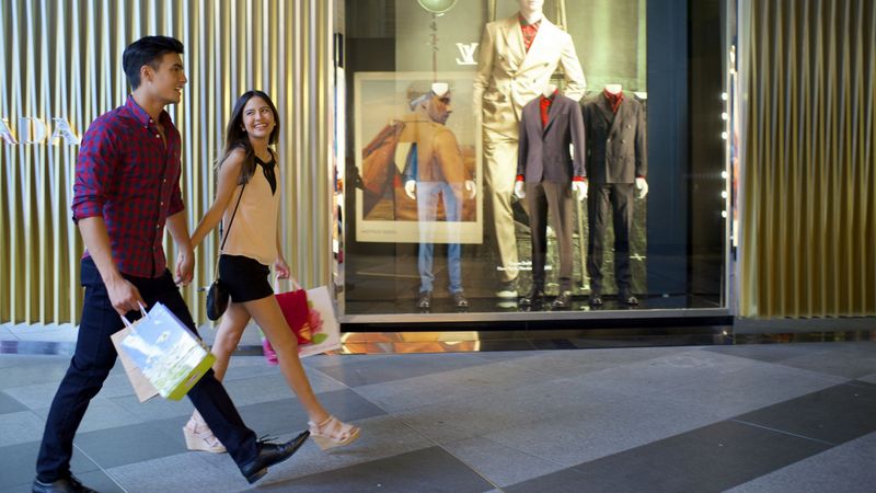 A couple outside Prada shop passing by ION Orchard
