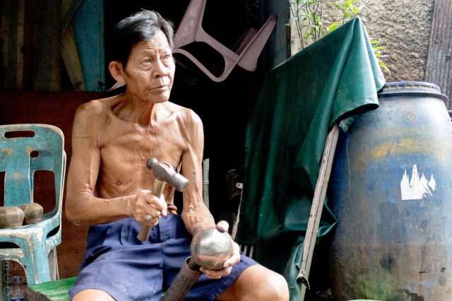 This man is crafting alms bowls for monks