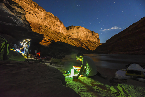 Chris Atwood treats water with a UV water filter. While walking the length of the Grand Canyon, hikers will consume up to 6 or more liters a day. Atwood is on a 56 consecutive thru-hike.