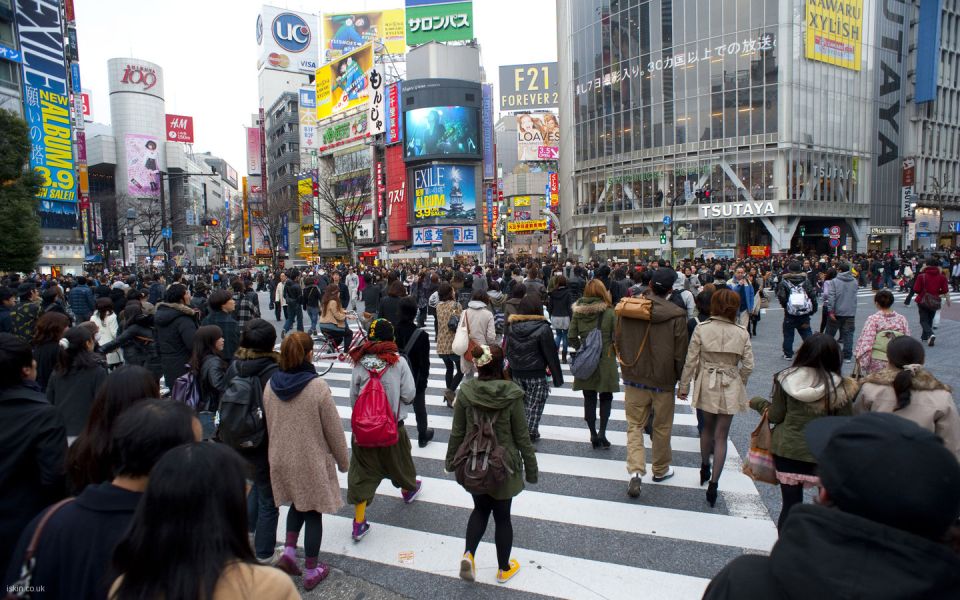 Urban bustle, people crossing a busy cross walk in Shibuya, Tokyo, Japan
