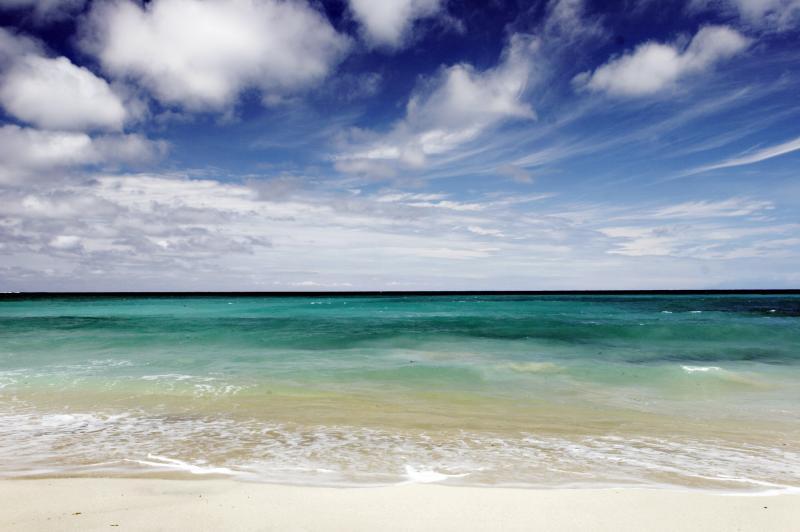 Try your hand at surfing at the beautiful Dreamland Beach in Bali.