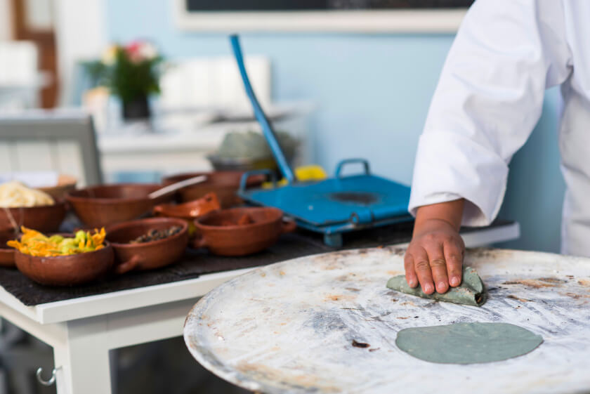 Delicious, handmade blue corn tortillas are made and served with fresh zucchini flowers, chiles and queso.