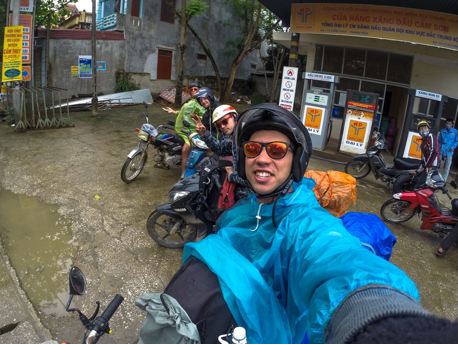 wearing a raincoat it is raining motorbike vietnam