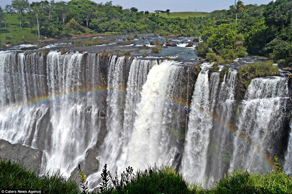 The incredible images of the highliner crossing a waterfall were taken just as a rainbow framed the shot. Image by Caters News Agency