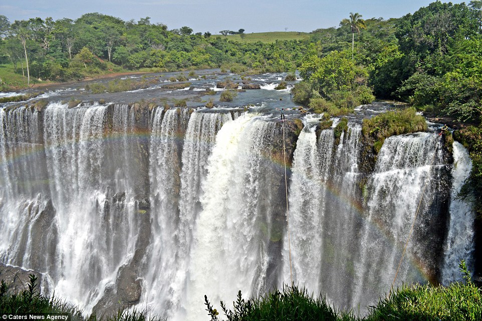 Brazilian highliner Reginaldo Gomes, 34, crossed the Cachoeira da Fumaça just as the stunning arc of a rainbow formed. Image by Caters News Agency