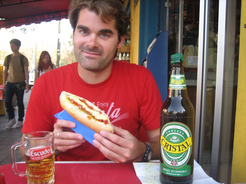 A tourist is about to enjoy a completo Photo: goneroaming