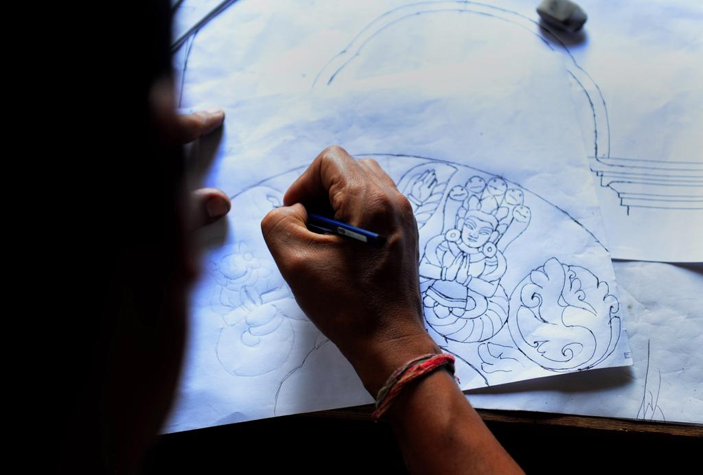 Nepalese woodcarver Hari Bahadur Shilpakar works in a workshop in Bhaktapur on the outskirts of Kathmandu. Prakash Mathema / AFP