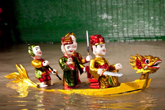 watching water puppet show vietnam travel