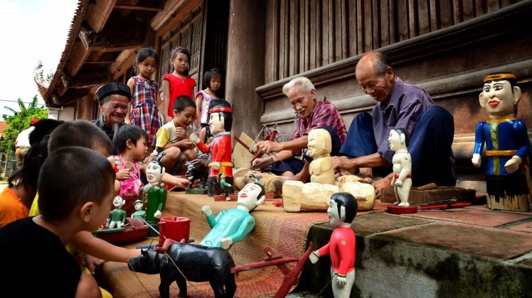watching water puppet show vietnam travel