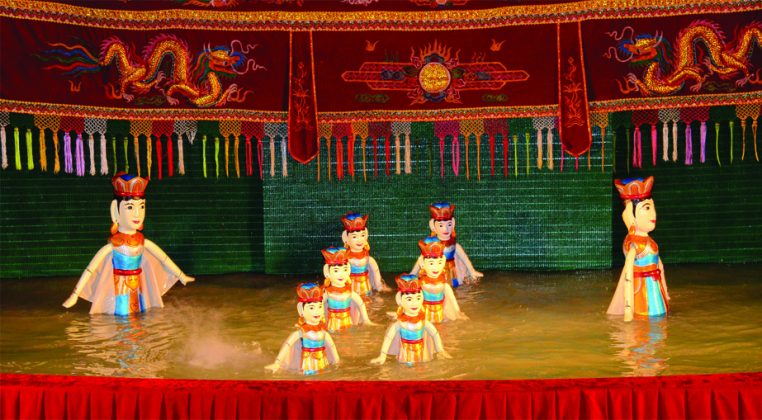 watching water puppet show vietnam travel
