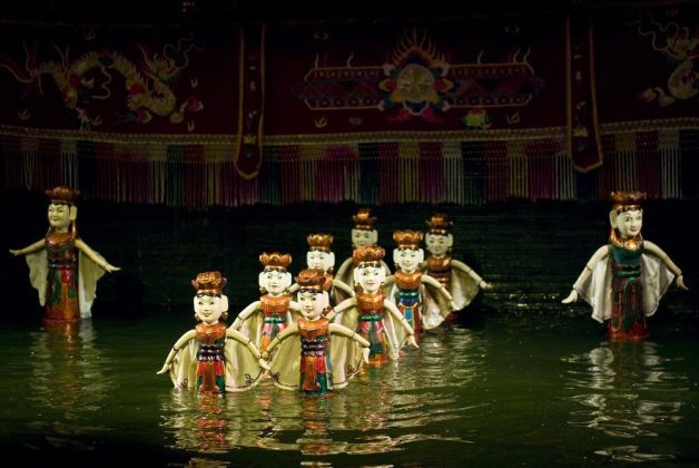watching water puppet show vietnam travel