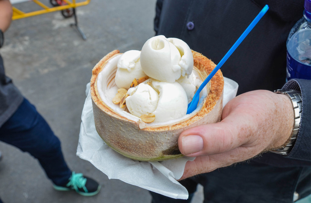 Enjoying the coconut cream, Bangkok . One of the top fun things to do in Bangkok for the first time visitors.