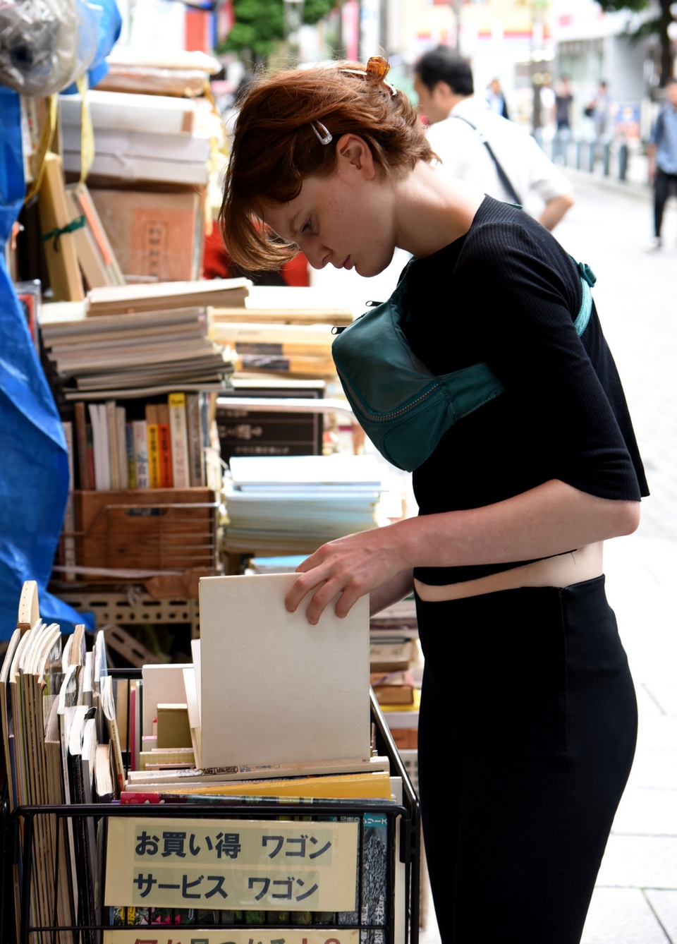 A shopper browses art books at a store selling used volumes in Tokyo's Jinbocho neighborhood.