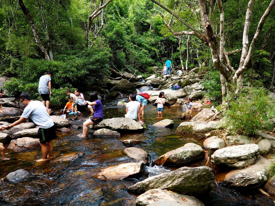People paddling in the stream near Bride's Pool, Plover Cove unique things to do in hong kong hong kong hidden gems hong kong unique experiences