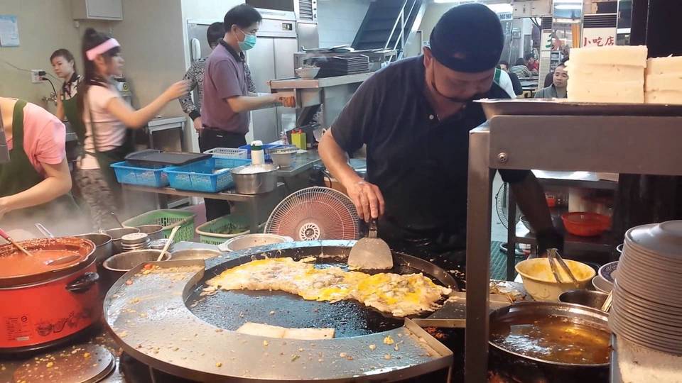 'The guy is cooking the oyster omelet tourists ordered
