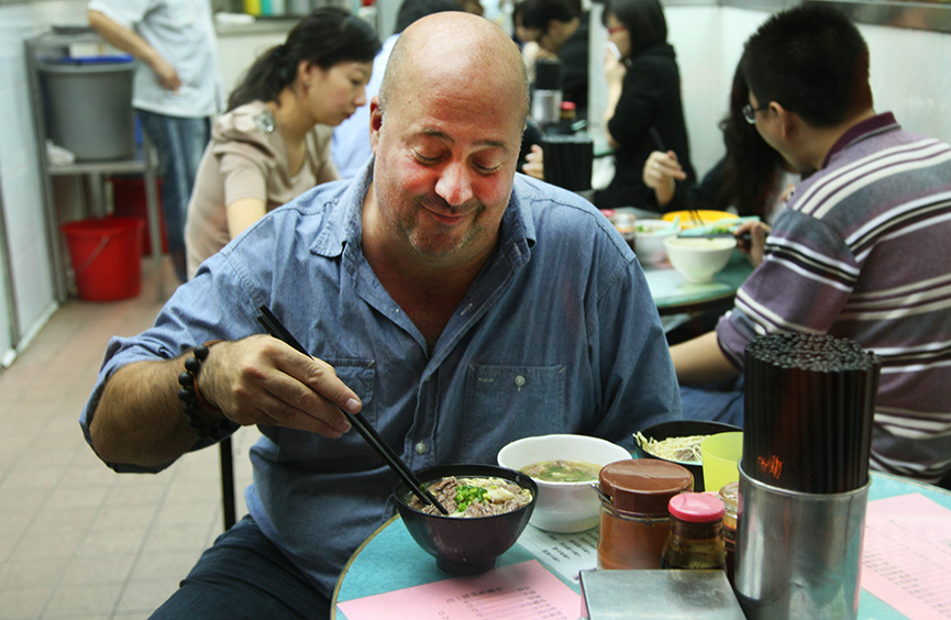 Tourist enjoys Kau Kee beef brisket noodle