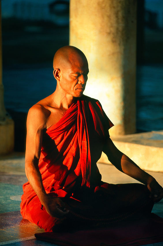 Buddhist monk meditating at Shwezigon Pagoda, Bagan (Pagan), Myanmar (Burma).