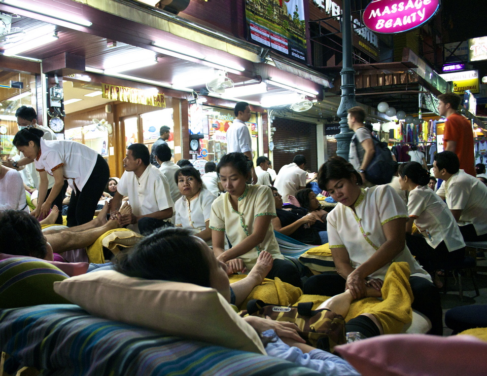 Massage chairs and patrons propped out on the street late into the night. $6 for one hour. Khao San road.
