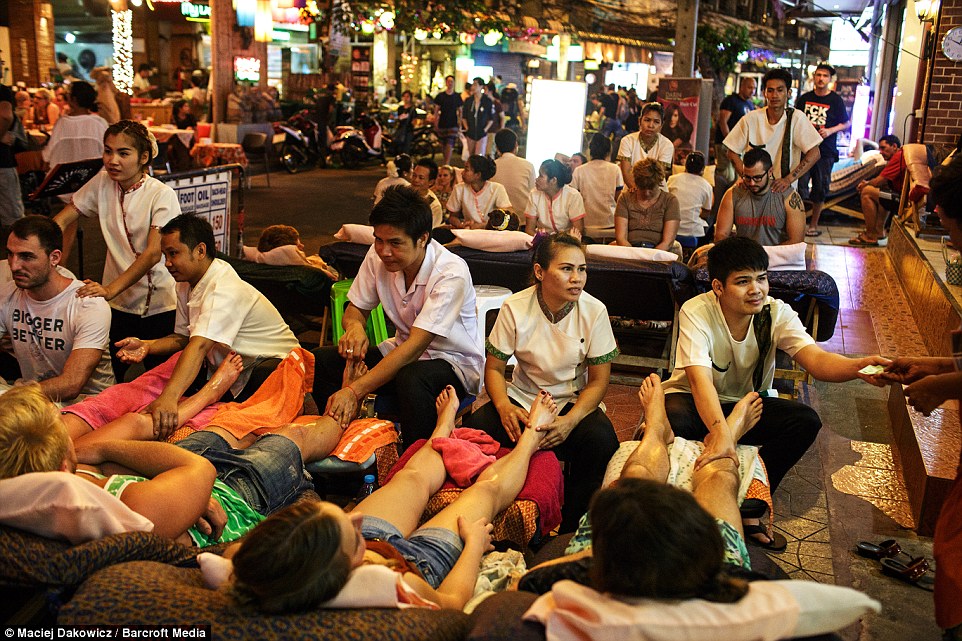 where to go for massage in bangkok People enjoy a leg massage on the streets as they are photographed by an intrepid photographer