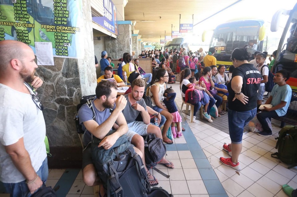 Tourists and locals wait for their bus rides at the North Bust Terminal