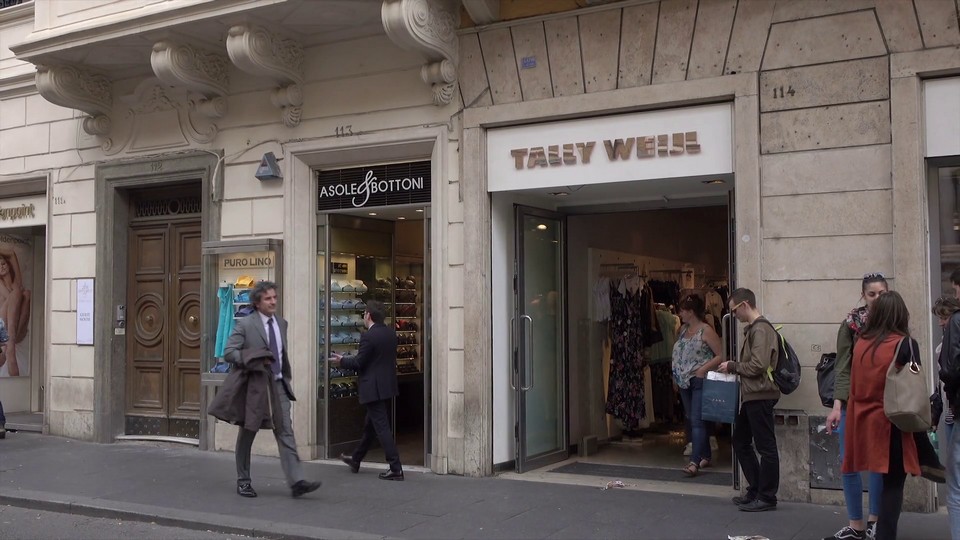 People walk and shop on Via del Corso shopping street, Rome, Italy, pan Stock Video Footage - Storyblocks Video