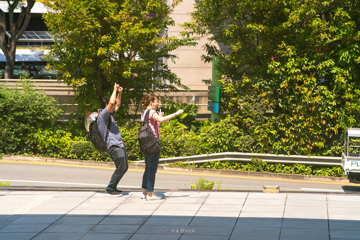 Tourists taking selfies on Sentosa island, Singapore.