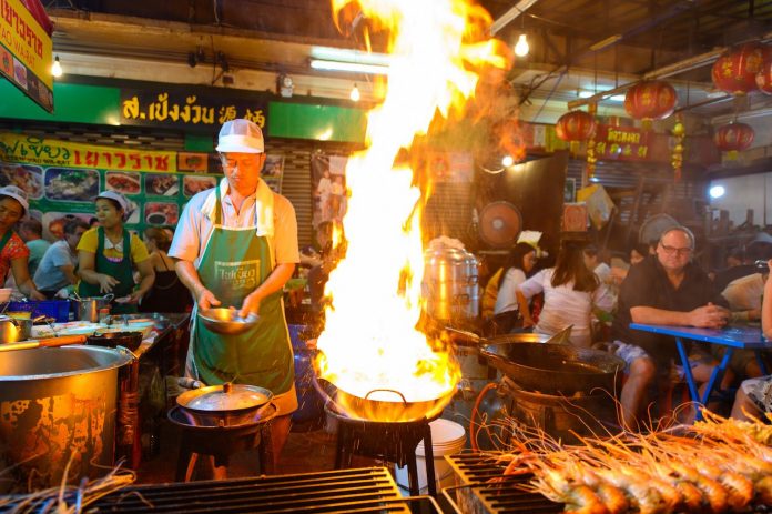 best food in bangkok Street-food-chef-cooking-with-fire-at-Yaowarat-road-in-Bangkok