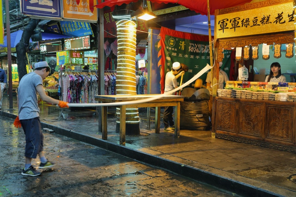 Unidentified-man-making-handmade-pasta-in-a-food-store-on-a-rainy-day-in-the-Muslim-Quarter-of-Xian-China